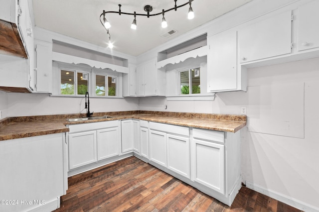 kitchen with white cabinetry, sink, and a wealth of natural light