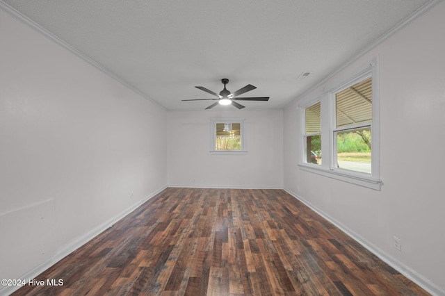 spare room with ceiling fan, dark wood-type flooring, and ornamental molding