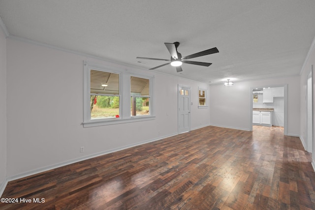 spare room featuring ceiling fan, crown molding, dark wood-type flooring, and a textured ceiling