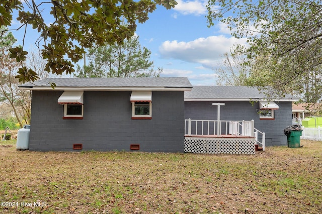 back of house featuring a yard and a wooden deck