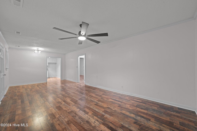 spare room featuring a textured ceiling, dark hardwood / wood-style floors, ceiling fan, and crown molding