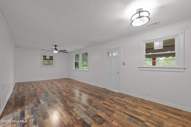 interior space with a textured ceiling, dark hardwood / wood-style flooring, and plenty of natural light