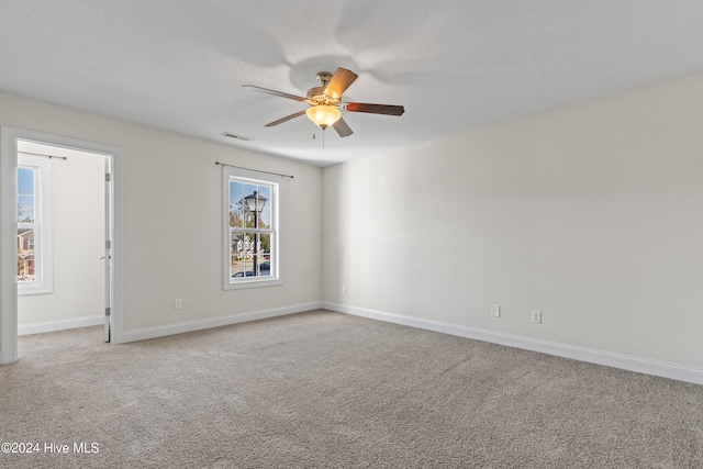 unfurnished room with ceiling fan and light colored carpet