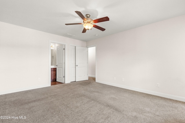 unfurnished bedroom with ceiling fan, carpet, and ensuite bathroom