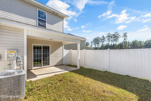 view of yard featuring central AC unit and a patio