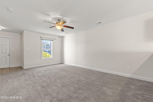 carpeted empty room featuring ceiling fan