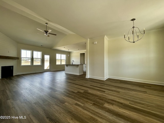 unfurnished living room featuring dark wood-style flooring, lofted ceiling, a large fireplace, baseboards, and ceiling fan with notable chandelier