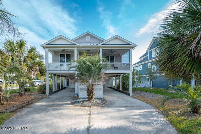 3207 E Oak Island Dr, Oak Island, NC 28465 - beach home featuring a carport, a ceiling fan, a porch, and driveway