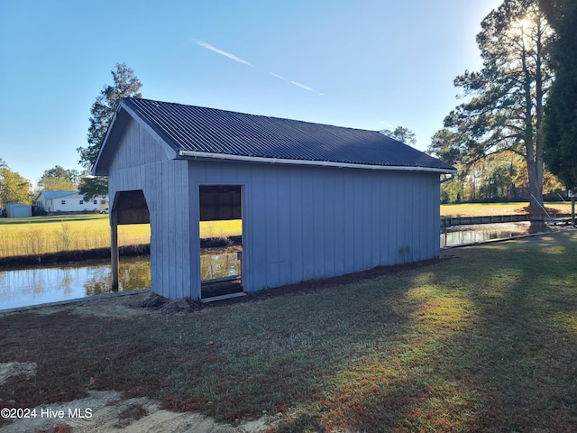 view of home's exterior featuring a yard and a water view