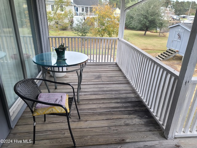 wooden terrace featuring a storage shed