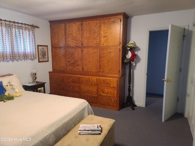 carpeted bedroom with a textured ceiling