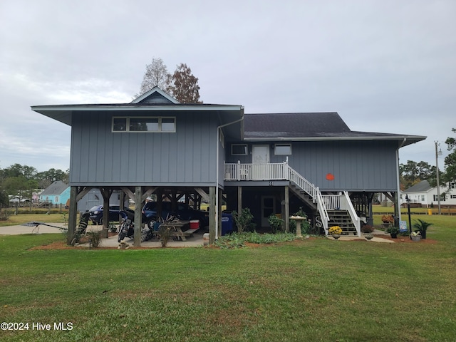 rear view of property with a lawn and a patio