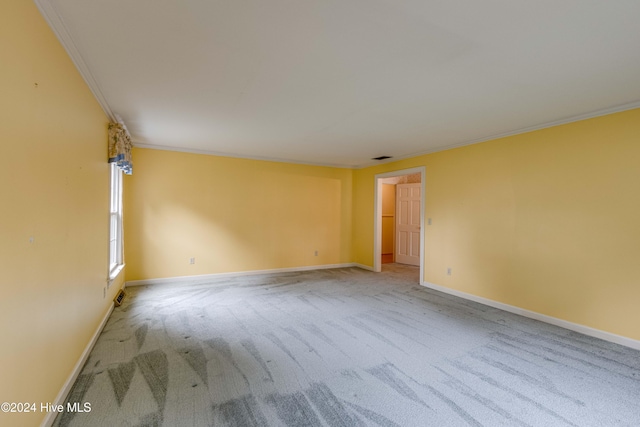 empty room featuring light carpet and ornamental molding