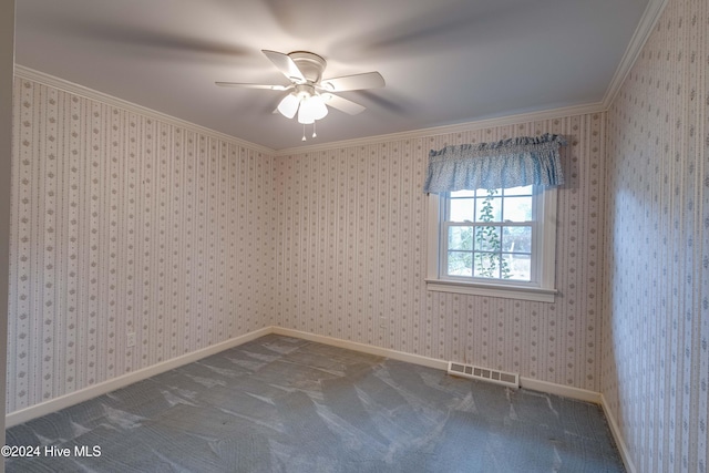 carpeted spare room with ceiling fan and crown molding