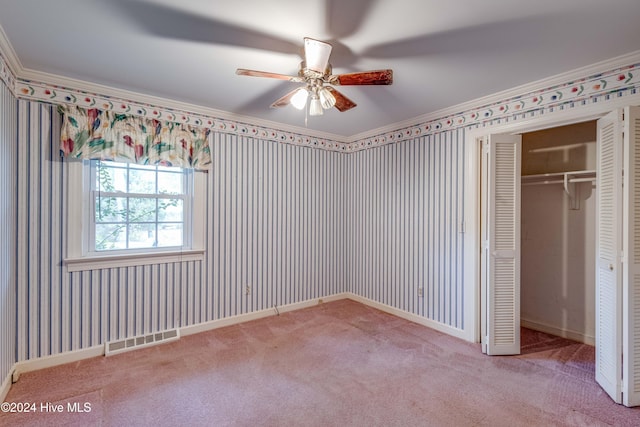 unfurnished bedroom with ceiling fan, ornamental molding, light carpet, and a closet