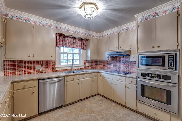 kitchen with backsplash, stainless steel appliances, crown molding, sink, and cream cabinets