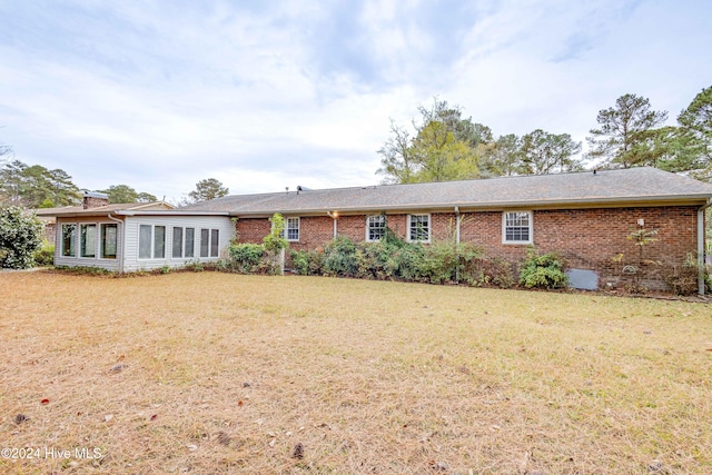 back of house with a lawn