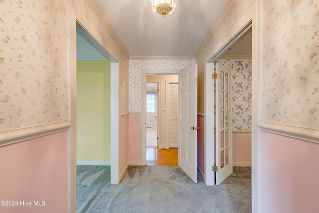 corridor with light colored carpet and ornamental molding