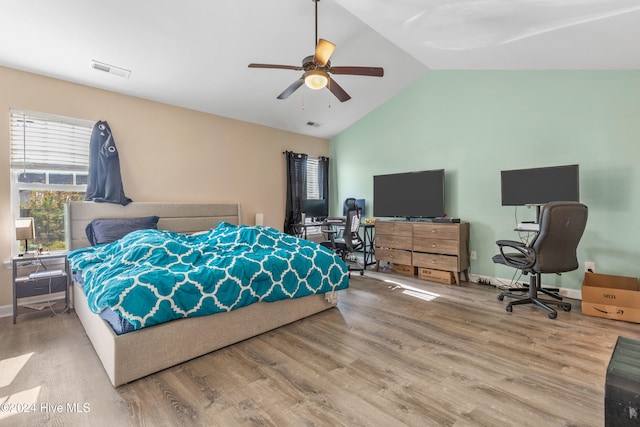 bedroom featuring hardwood / wood-style floors, vaulted ceiling, and ceiling fan