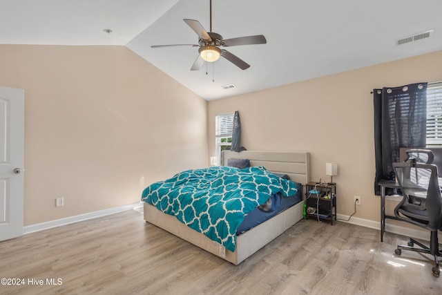 bedroom with hardwood / wood-style flooring, ceiling fan, and lofted ceiling