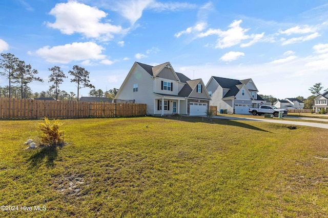 view of front of home featuring a front yard and a garage