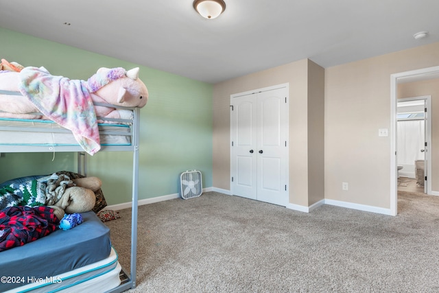 bedroom with carpet and a closet