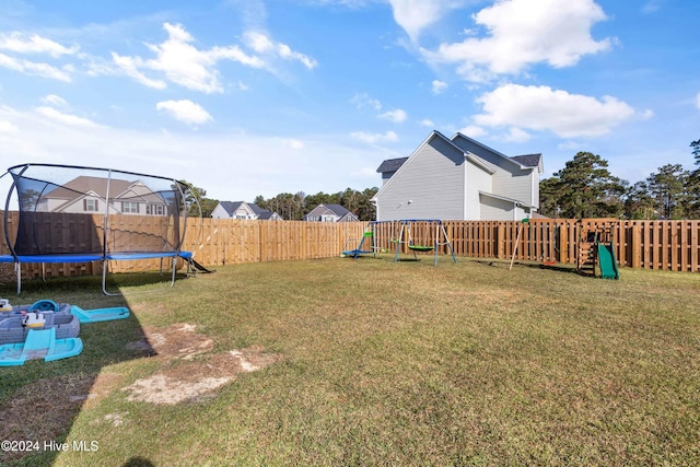 view of yard featuring a playground and a trampoline