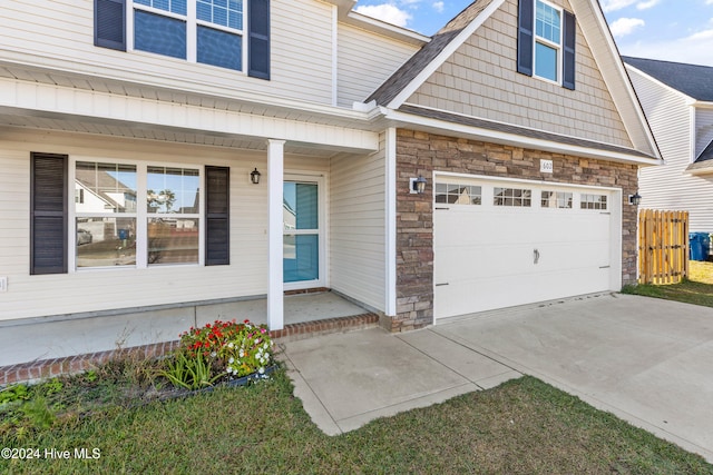 view of front facade featuring a porch and a garage