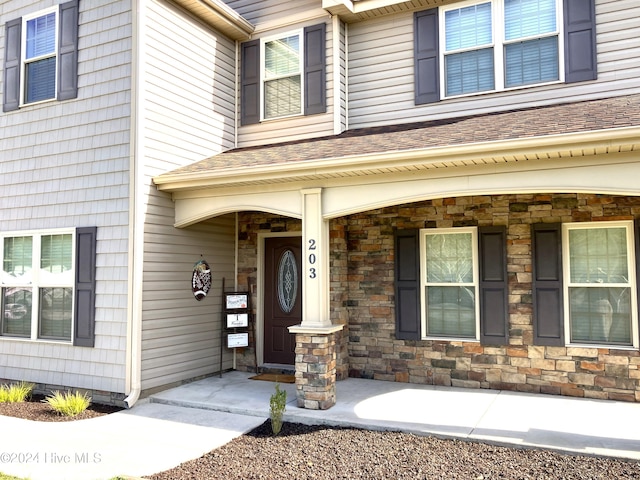 property entrance featuring a porch