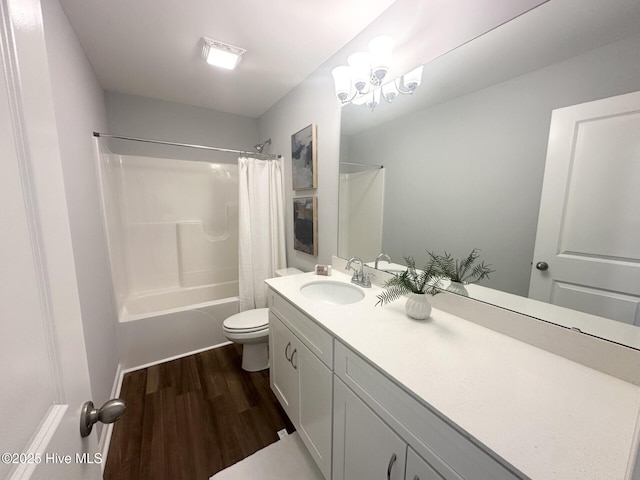 full bathroom with a notable chandelier, shower / bathtub combination with curtain, toilet, vanity, and wood finished floors