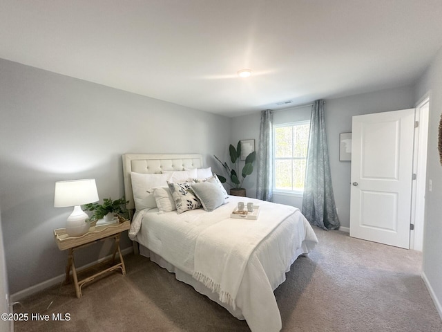 carpeted bedroom featuring baseboards