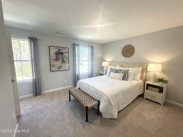 bedroom featuring carpet, visible vents, baseboards, and multiple windows