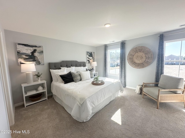 bedroom featuring carpet and baseboards