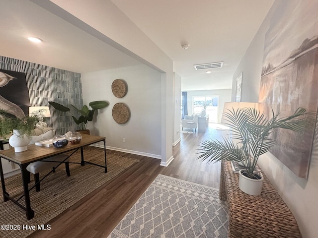 office space featuring visible vents, baseboards, and dark wood finished floors