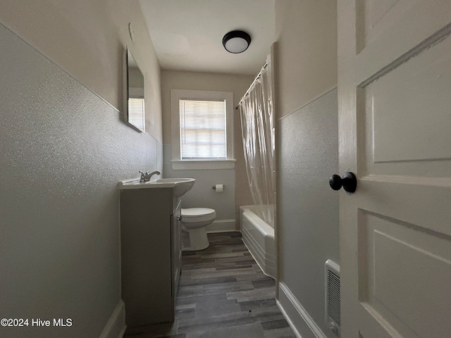 full bathroom with toilet, vanity, hardwood / wood-style floors, and shower / bathtub combination with curtain