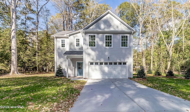 view of property with a garage and a front lawn