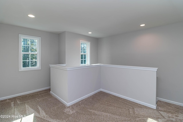 carpeted empty room with plenty of natural light