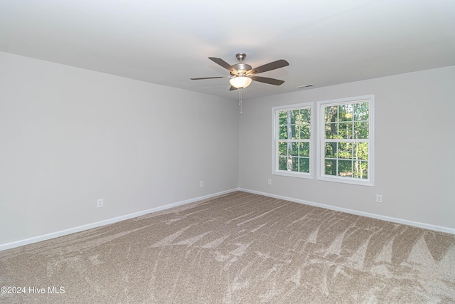 carpeted empty room featuring ceiling fan