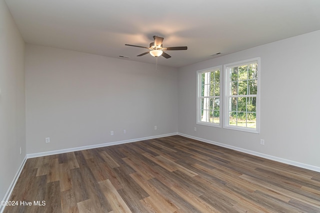 spare room featuring ceiling fan and dark hardwood / wood-style flooring