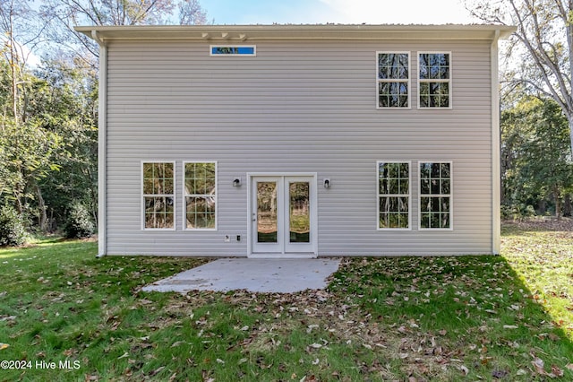 rear view of house featuring a yard and a patio