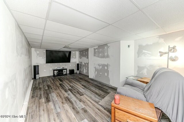 living room with a paneled ceiling and hardwood / wood-style flooring