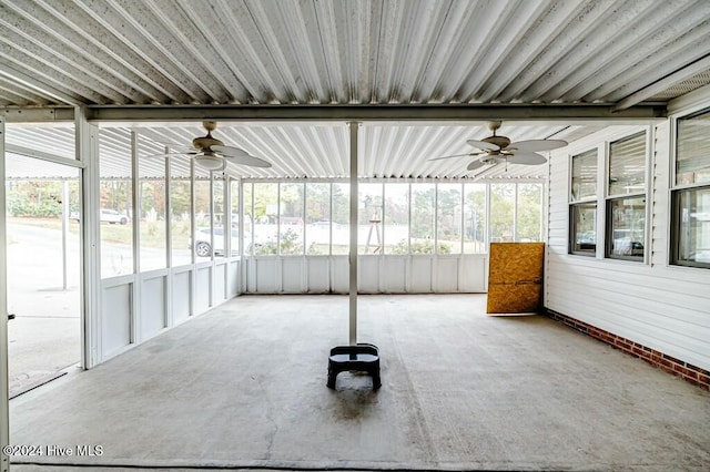 unfurnished sunroom featuring ceiling fan