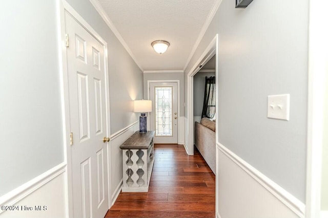 entryway with ornamental molding and dark wood-type flooring