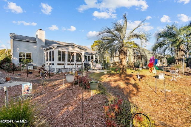 back of house featuring a sunroom