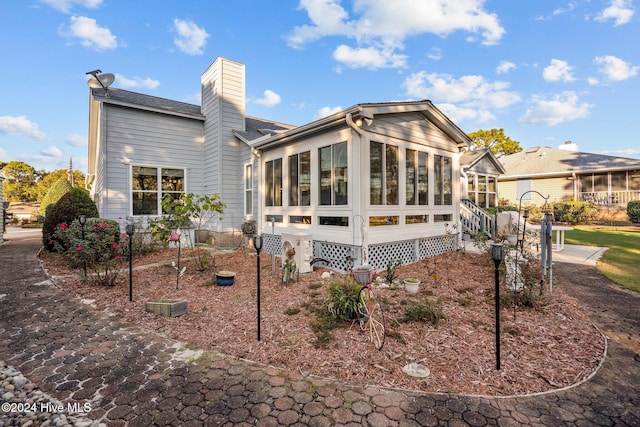 back of house with a sunroom