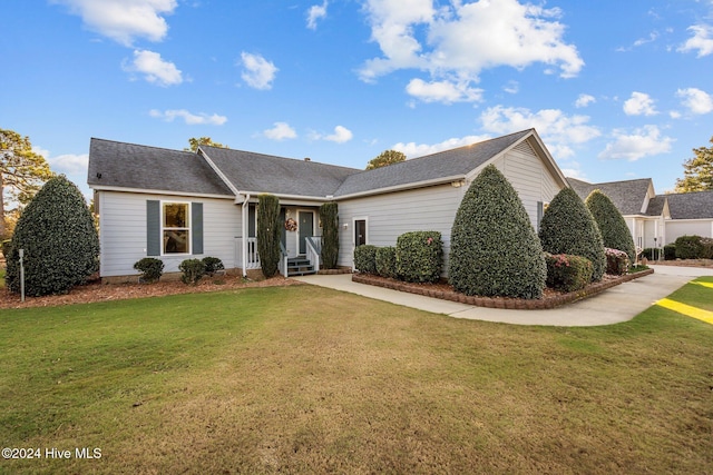 single story home featuring a front lawn