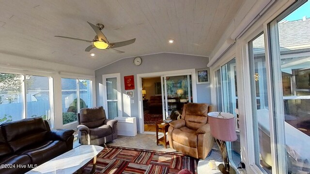 sunroom featuring vaulted ceiling, wood ceiling, and ceiling fan