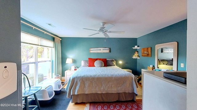 bedroom with wood-type flooring and ceiling fan