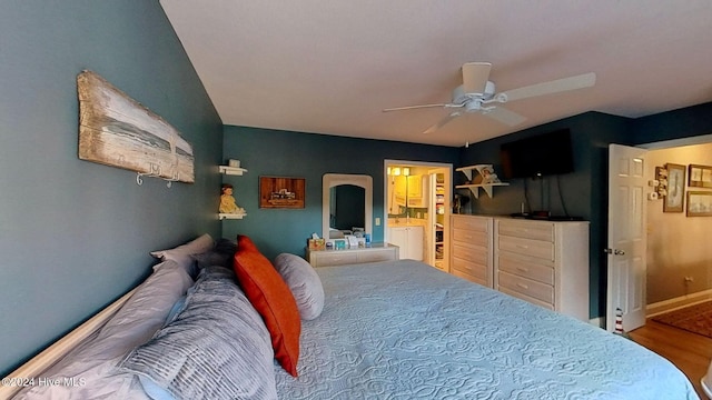 bedroom featuring hardwood / wood-style flooring, ceiling fan, and ensuite bath