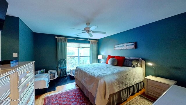 bedroom featuring wood-type flooring and ceiling fan